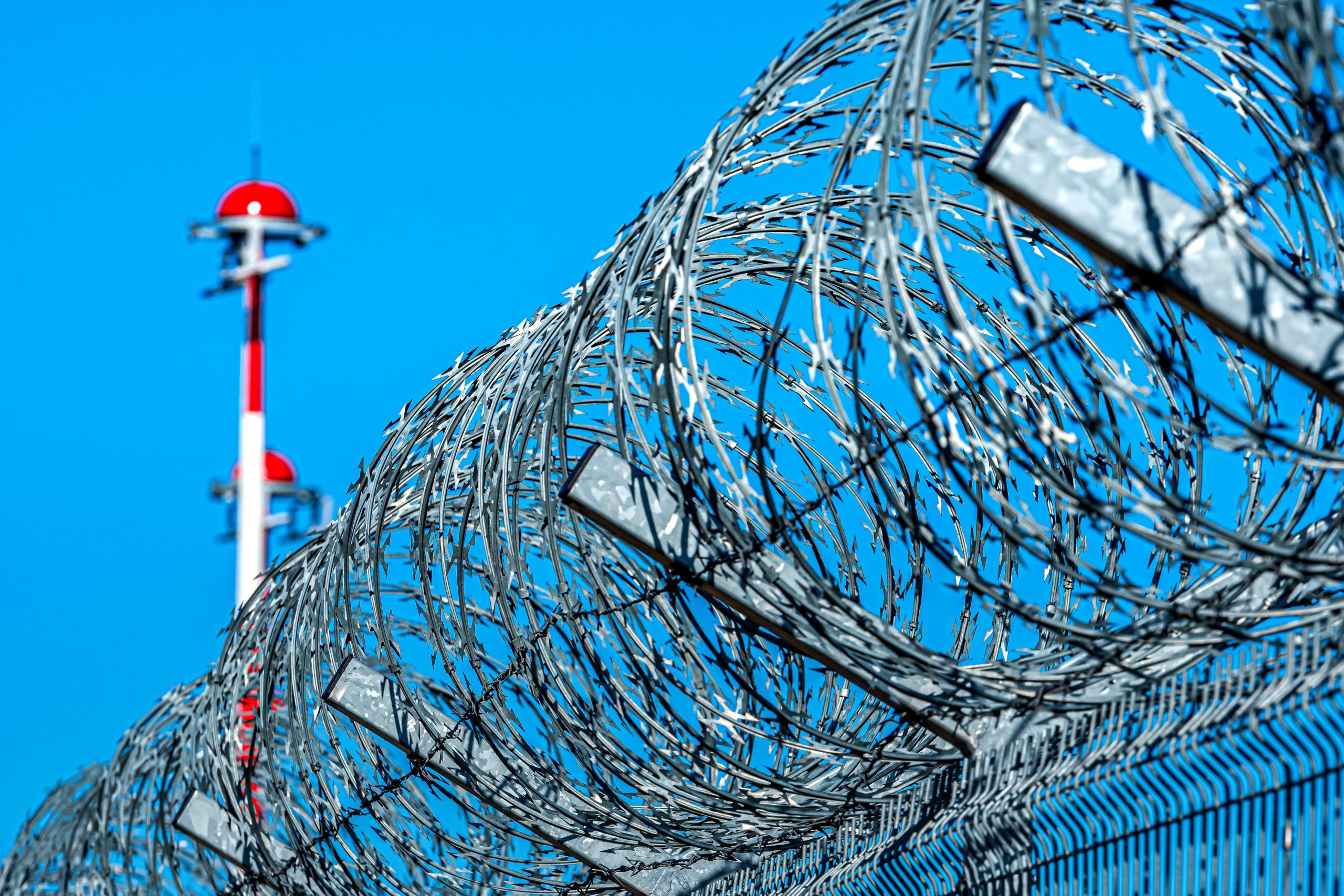 barbed wire fence protecting a correctional facility protected by a PIDS solution.